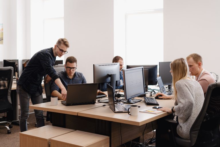 A professional, modern, and pleasantly bright corporate workspace in Bristol where expert SO Vision IT support engineers manage infrastructure tools and monitor system uptime dashboards